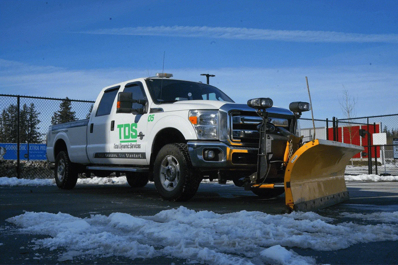 Commercial Snow Removal in Pitt Meadows, BC — TDS plow truck clearing snow from a commercial property in the Lower Mainland during winter