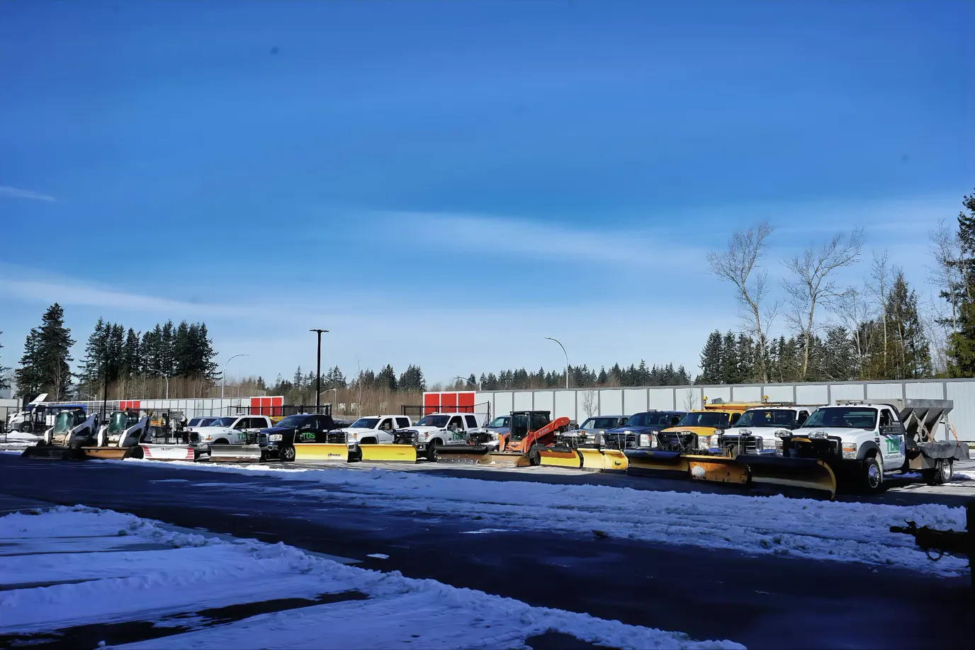 TDS Civil operator and company-owned snow and earthworks fleet staged at a commercial site